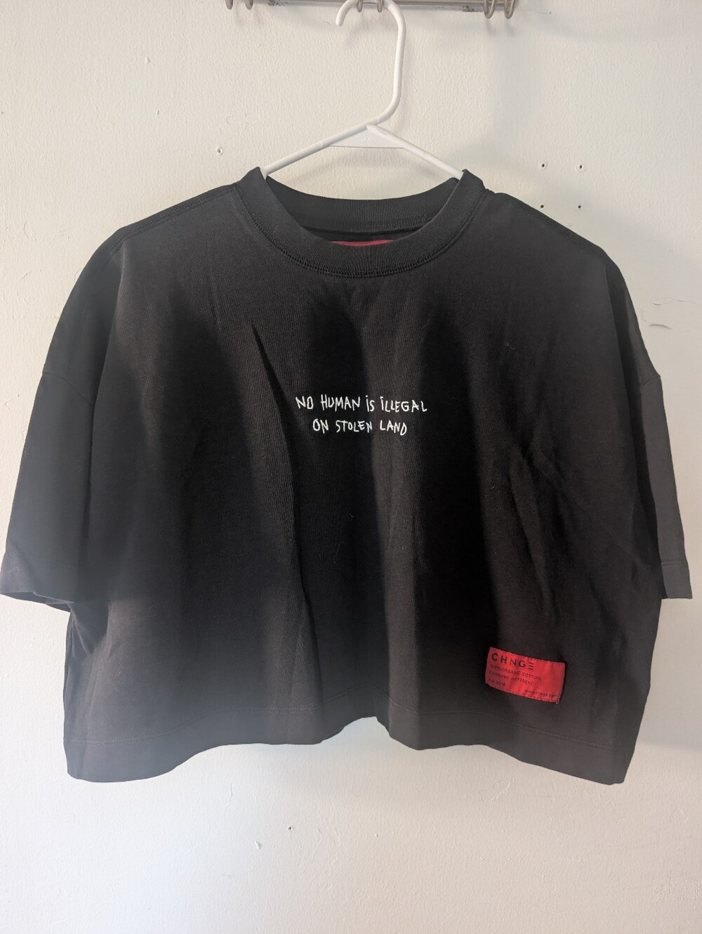 CHNGE "No Human is Illegal on Stolen Land" Cropped Tee